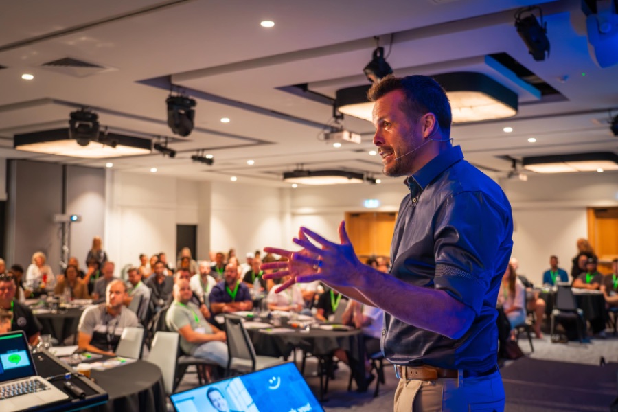 David Jenyns running a live systems workshop in front of a room of business owners